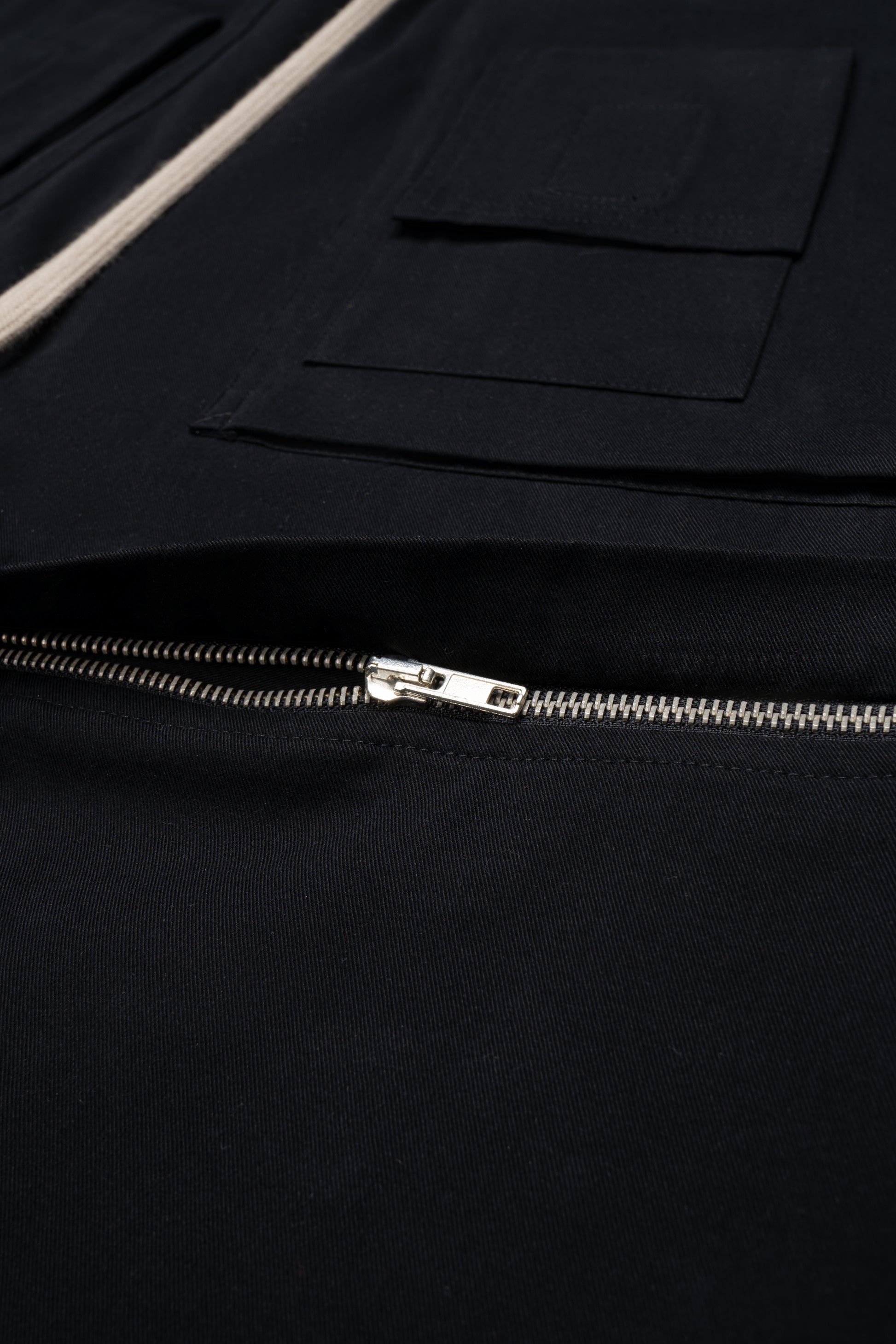 Zipper detail of black convertible pants