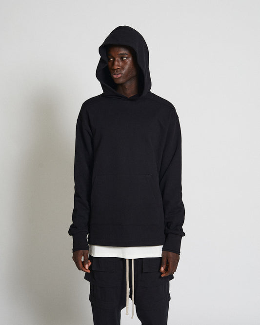 Font shot of male model wearing black basic hoodie and convertible pants