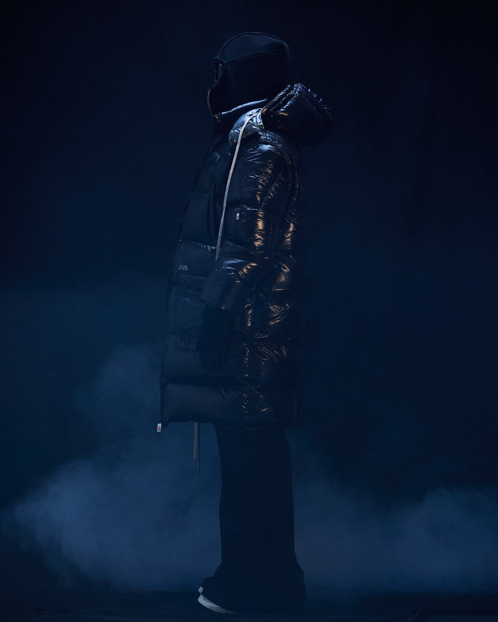 Profile of model wearing Blackout duvet coat in black