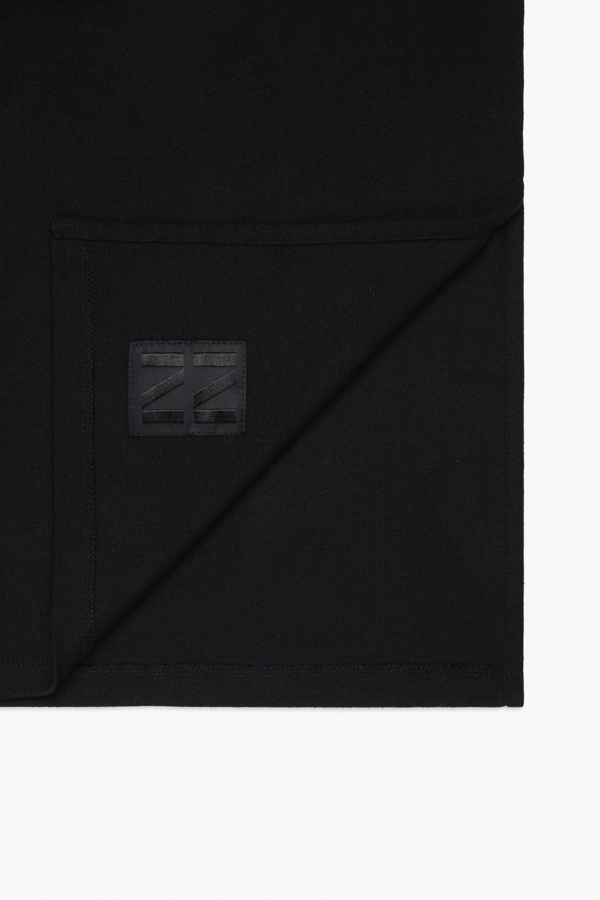 Close up of inside label of black long sleeve t-shirt ovnnie